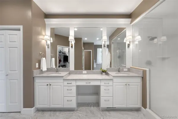 a bathroom with a granite countertop sink double and mirror