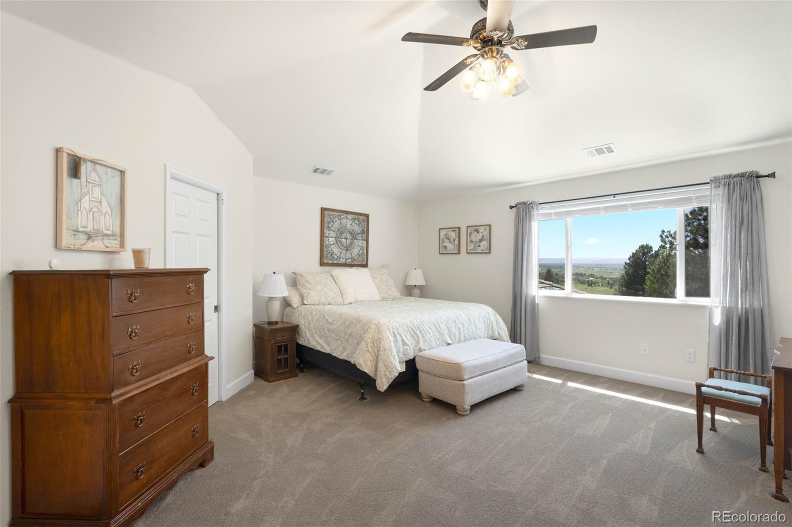 10914 Remmick Ridge Road Parker, CO 80134 - Photo 23 of 47 a spacious bedroom with a bed and a window