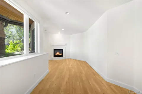 a view of a livingroom with wooden floor and a window