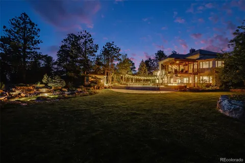 a view of a house with a yard patio and fire pit