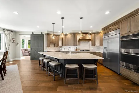 a large kitchen with a table and chairs