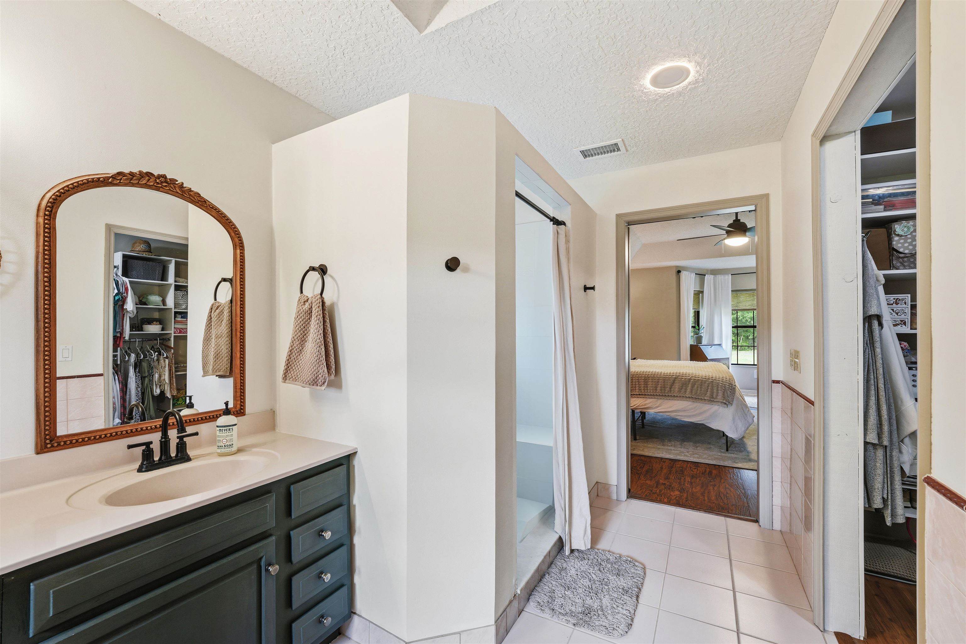 1805 Bennett Road St. Augustine, FL 32092 - Photo 25 of 65 a en suite bathroom with a double vanity sink and a mirror