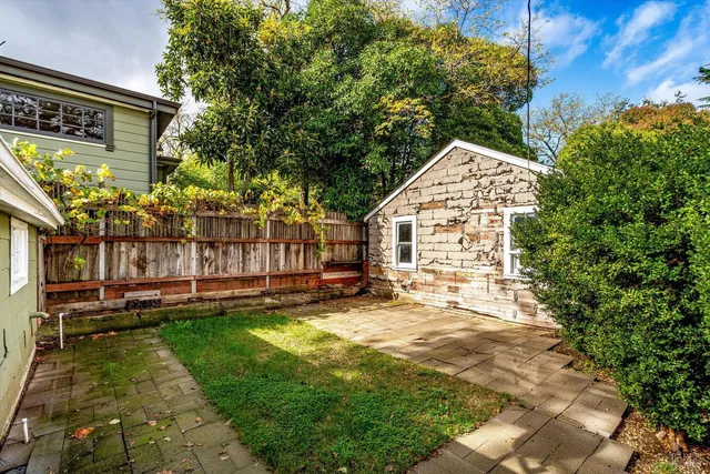 a view of a house with backyard and sitting area