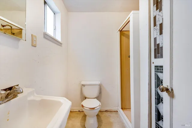 a white toilet sitting next to a bathroom sink