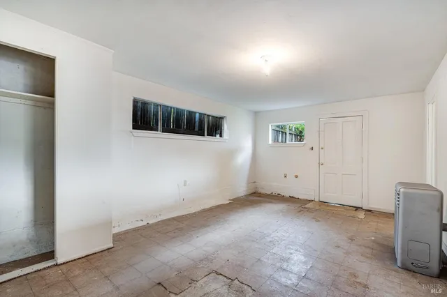 a view of a livingroom with an empty space and a workspace