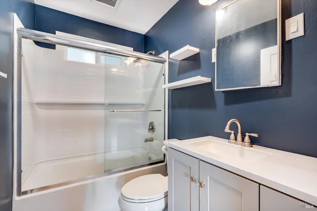 a bathroom with a sink a mirror and a shower