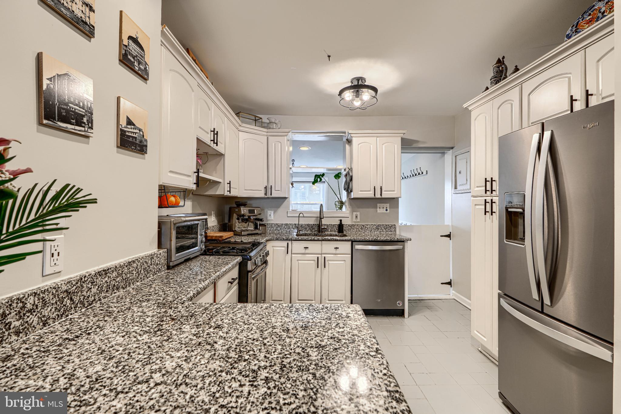 438 East Clement Street Baltimore, MD 21230 - Photo 14 of 47 a kitchen with stainless steel appliances granite countertop a refrigerator sink and stove