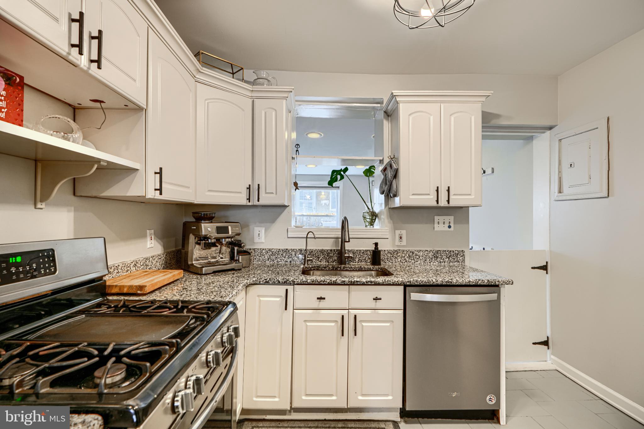 438 East Clement Street Baltimore, MD 21230 - Photo 16 of 47 a kitchen with granite countertop a stove and a sink