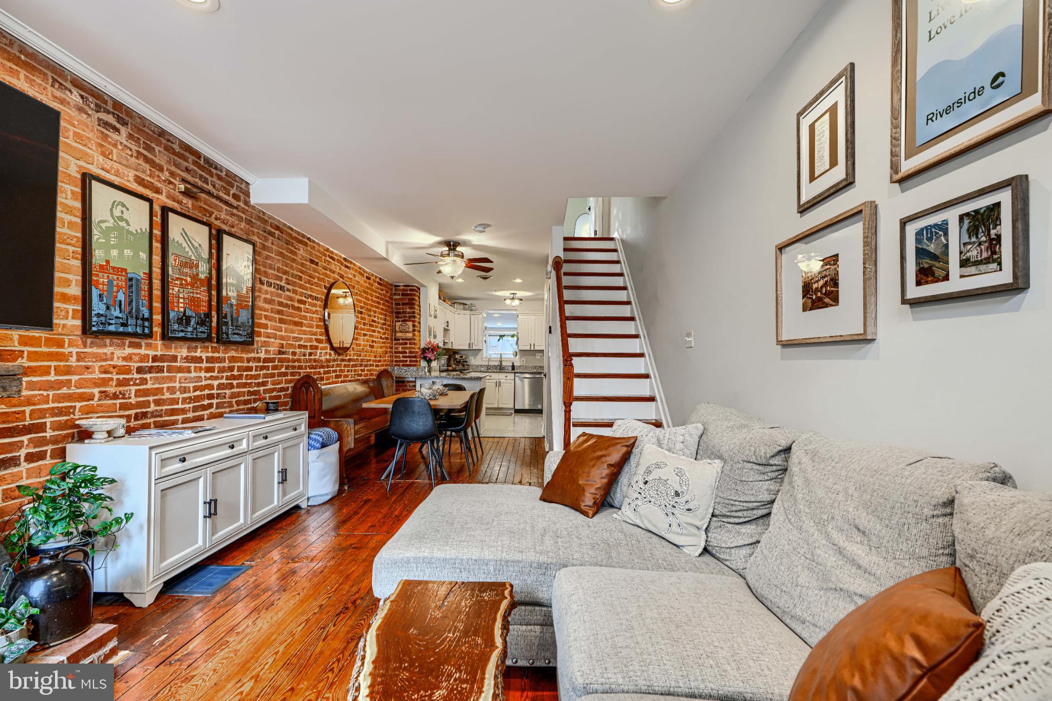 438 East Clement Street Baltimore, MD 21230 - Photo 6 of 47 a living room with furniture kitchen view and a wooden floor