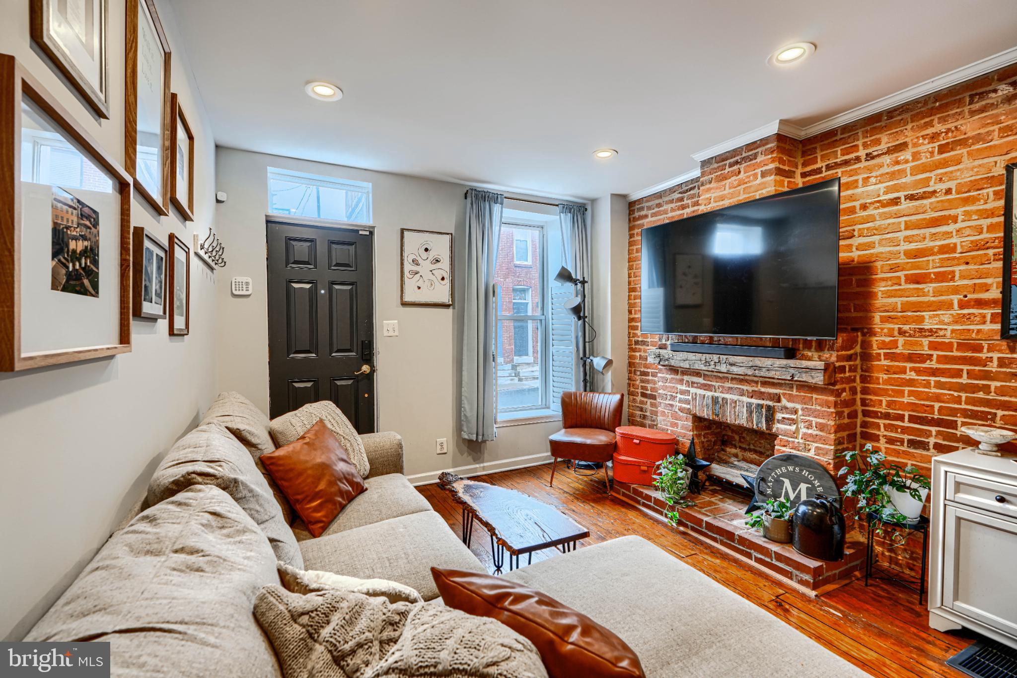 438 East Clement Street Baltimore, MD 21230 - Photo 7 of 47 a living room with furniture and a flat screen tv