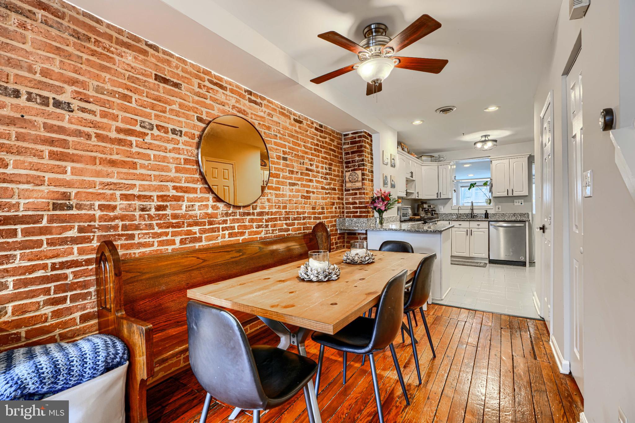 438 East Clement Street Baltimore, MD 21230 - Photo 9 of 47 a dining room with stainless steel appliances kitchen island granite countertop a table chairs and a rug