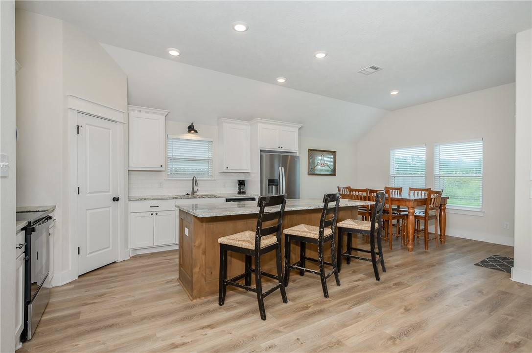 473 Brazos Bend Snook, TX 77879 - Photo 14 of 34 Kitchen featuring lofted ceiling, a kitchen island