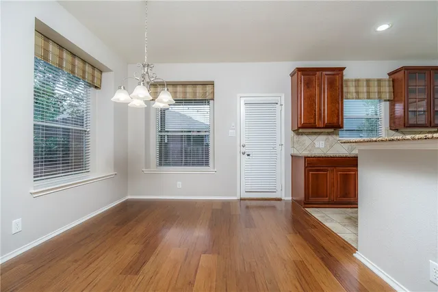 a view of livingroom with kitchen and hardwood floor