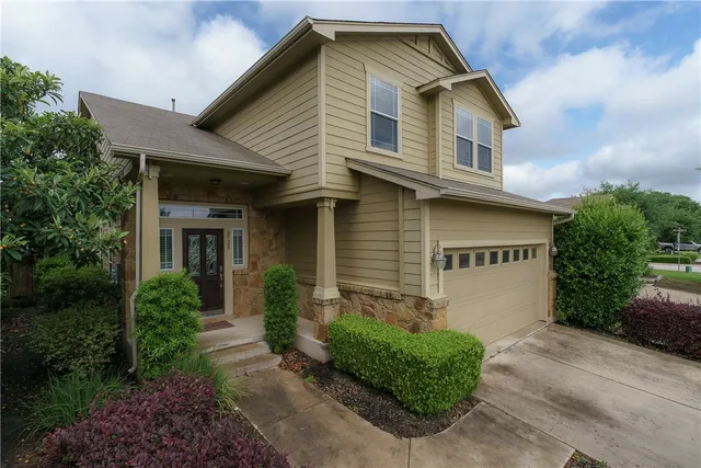 a front view of a house with garden