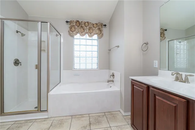 a bathroom with a tub sink and mirror