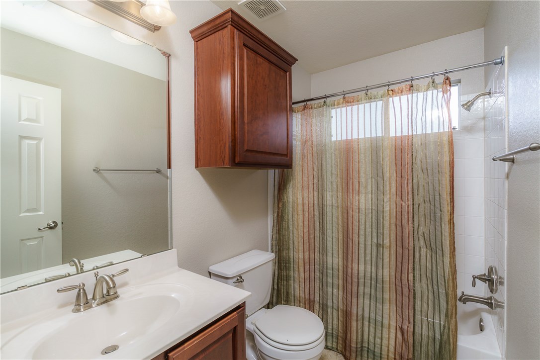 8528 Harrier Drive, Unit 233 Austin, TX 78729 - Photo 22 of 27 a bathroom with a sink a toilet and shower