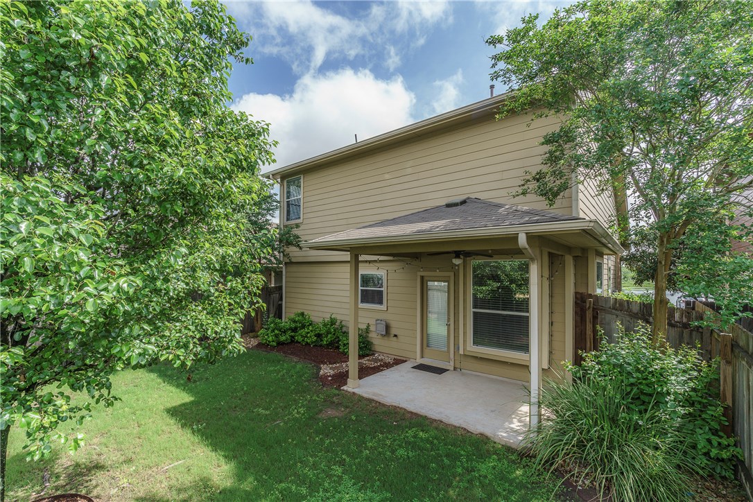8528 Harrier Drive, Unit 233 Austin, TX 78729 - Photo 24 of 27 a view of a white house with a big yard and large tree