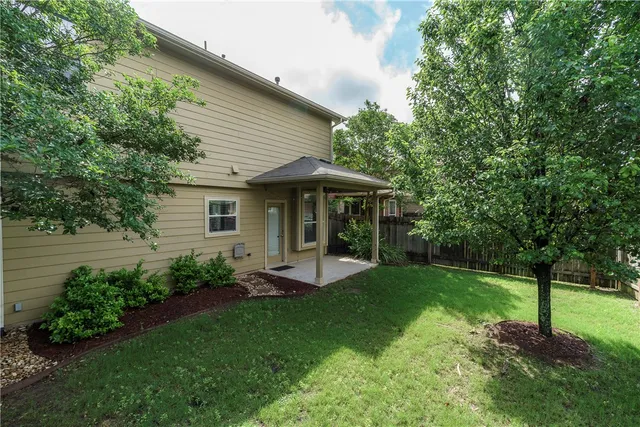 a view of a house with a yard and sitting area