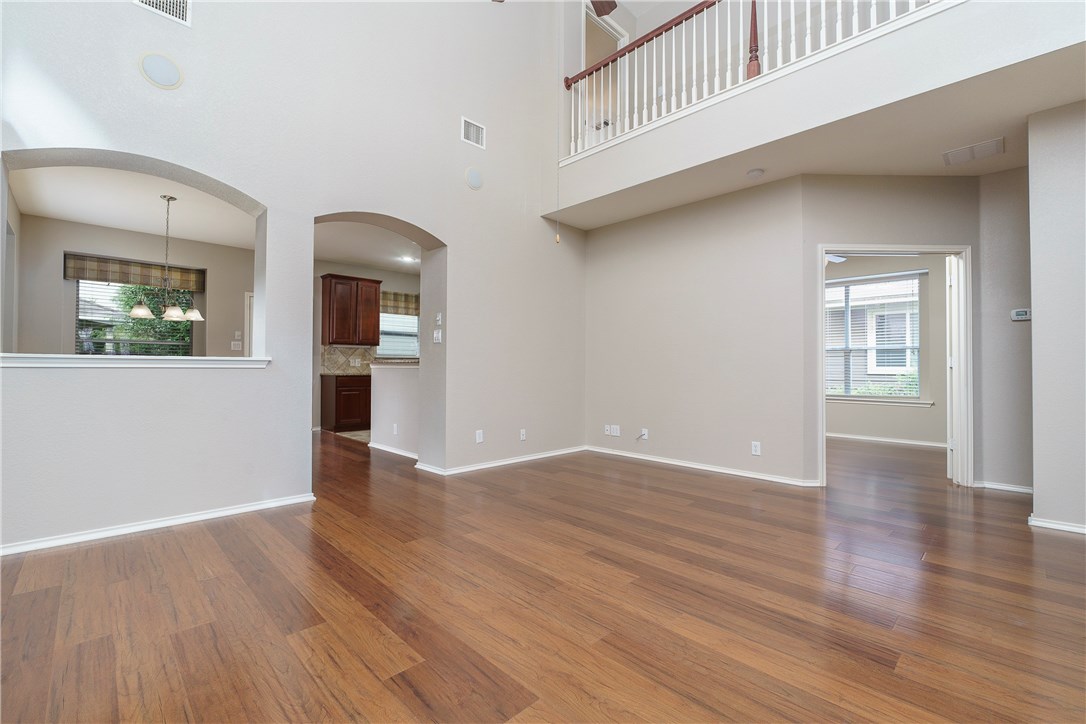 8528 Harrier Drive, Unit 233 Austin, TX 78729 - Photo 9 of 27 a view of an empty room with wooden floor and a window