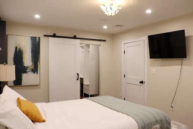a bedroom with a bed and a flat screen tv