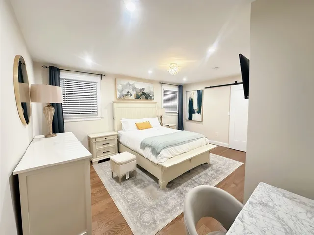 a bedroom with a bed a couch and dresser