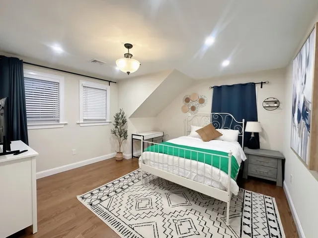 a bedroom with furniture and a chandelier