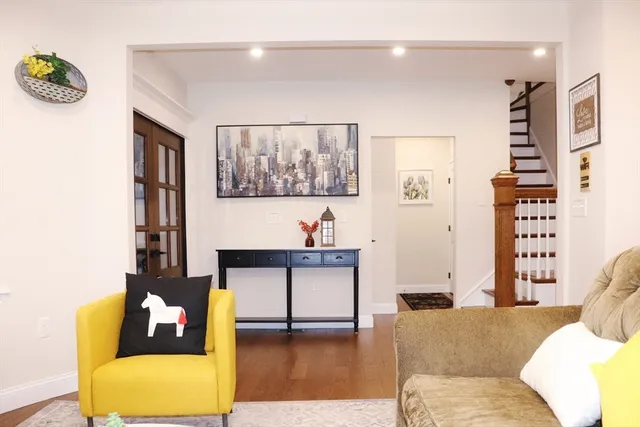 a living room with furniture and wall paintings