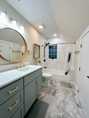 a bathroom with a double vanity sink mirror bathtub shower and toilet