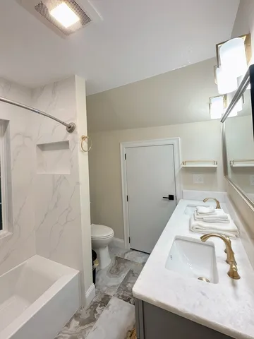 a bathroom with a sink toilet and shower