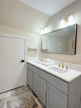 a bathroom with a double vanity sink and a mirror