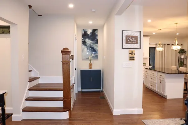 a view of entryway and hall with wooden floor