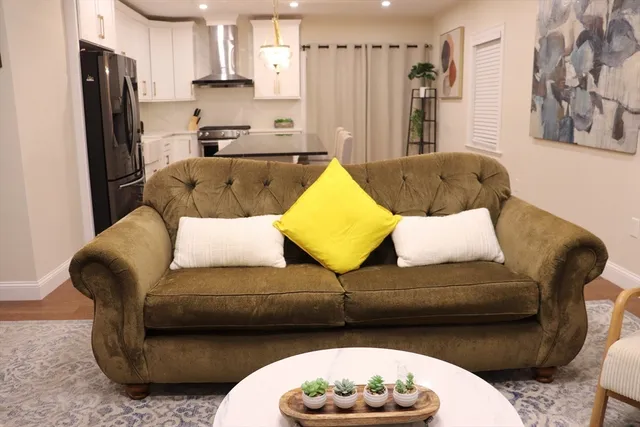 a living room with a couch and a refrigerator