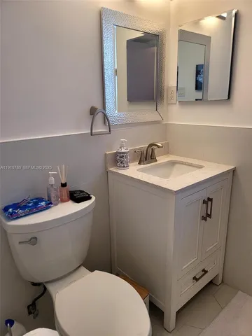 a view of a yard with potted plants and palm trees