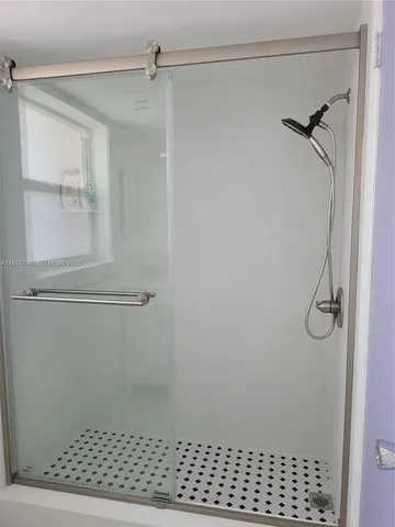 a backyard of a house with chairs and a yard with wooden fence