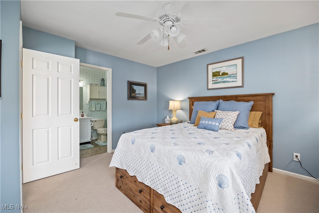 1507 Cleveland Road East, Unit 435 Huron, OH 44839 - Photo 15 of 37 Carpeted bedroom featuring ceiling fan and ensuite bathroom