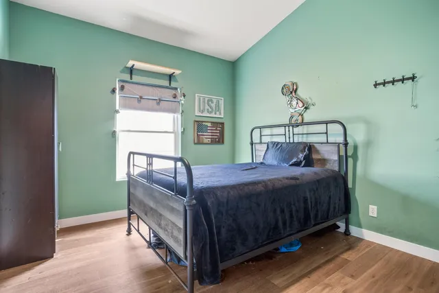 a bedroom with a bed and a window