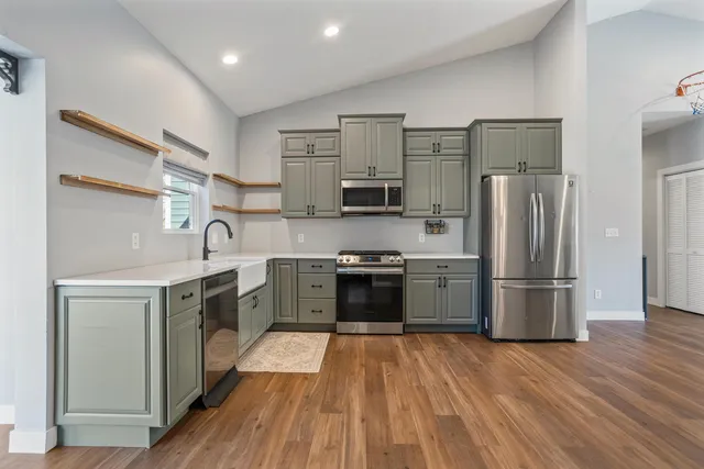 a kitchen with stainless steel appliances a refrigerator stove and sink