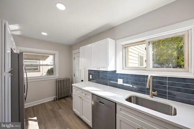 a kitchen with a sink and large window