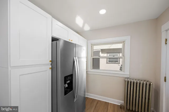 a kitchen with stainless steel appliances a refrigerator and a window