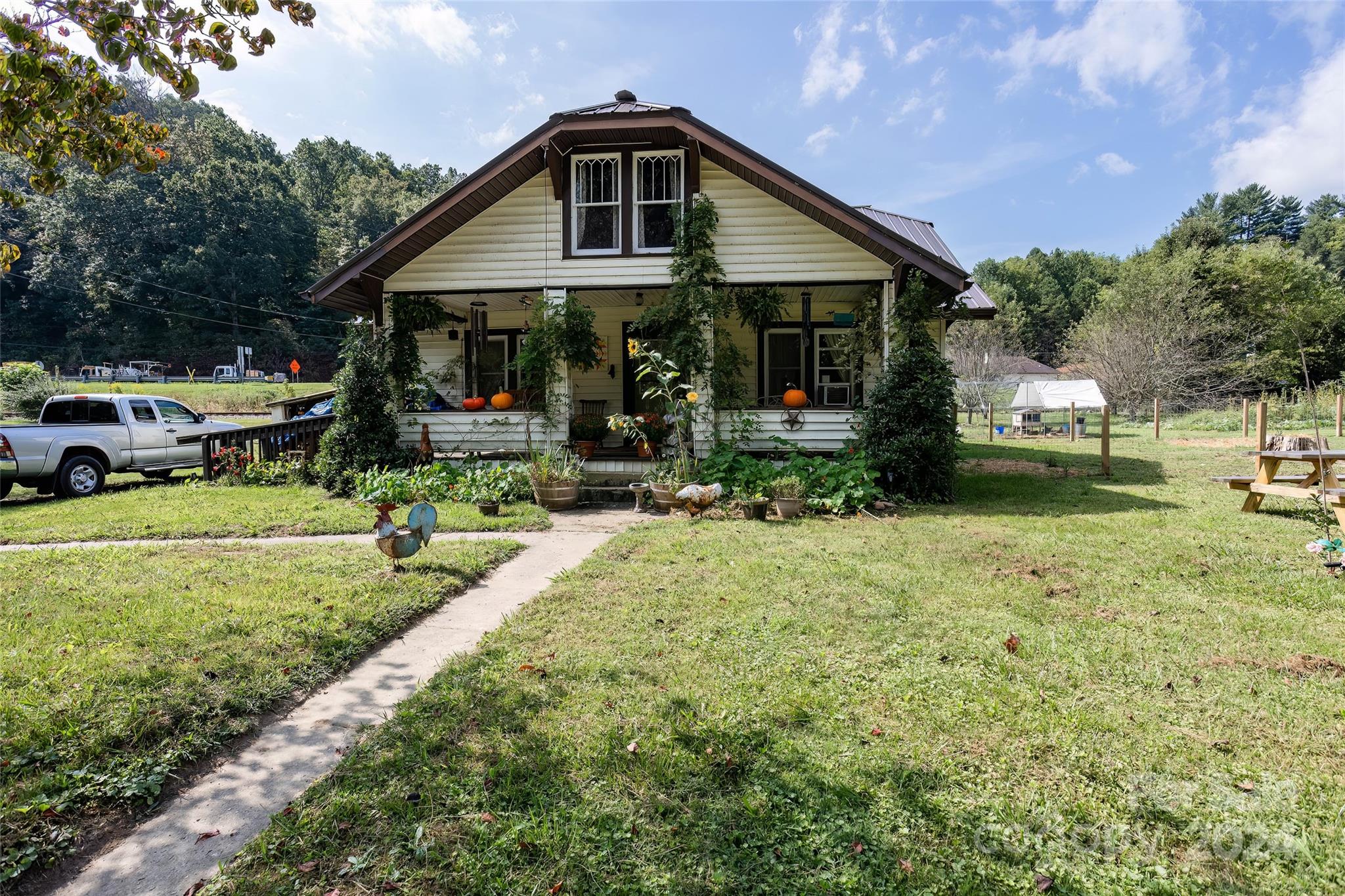 a front view of a house with garden and porch