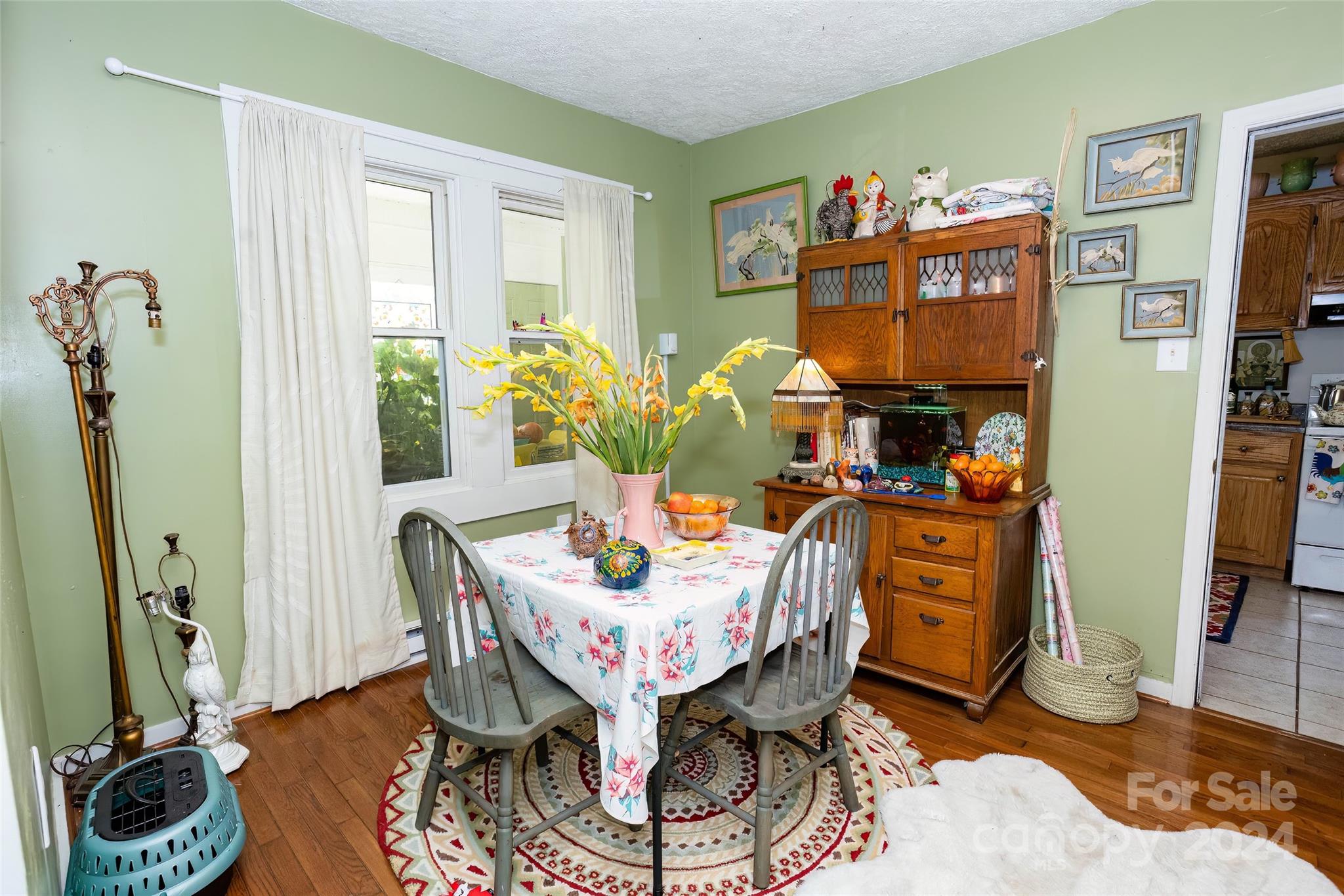 3786 Broad Street Clyde, NC 28721 - Photo 12 of 48 a living room with furniture a flat screen tv and a floor to ceiling window