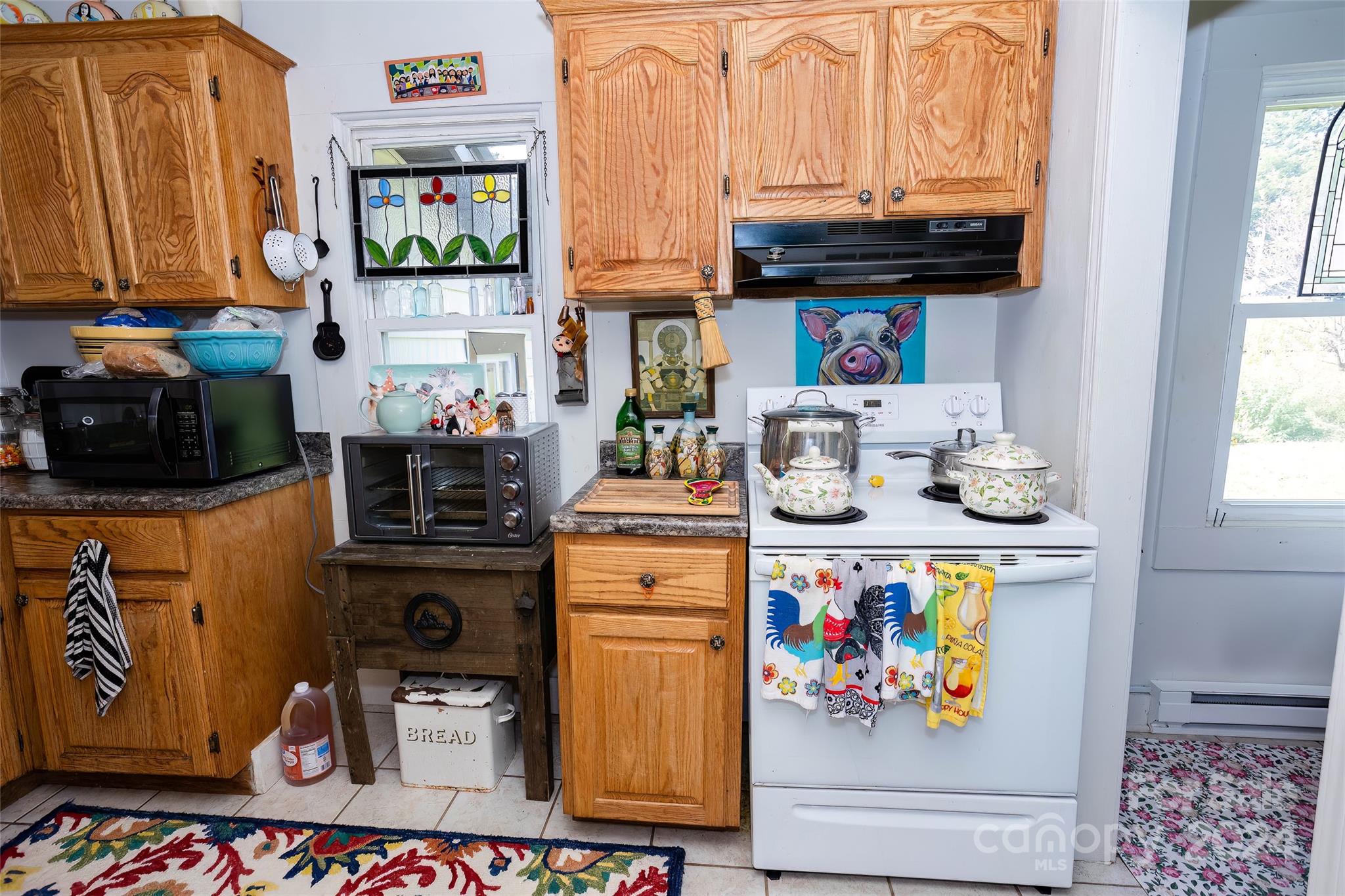 3786 Broad Street Clyde, NC 28721 - Photo 14 of 48 a kitchen with stainless steel appliances a stove and cabinets