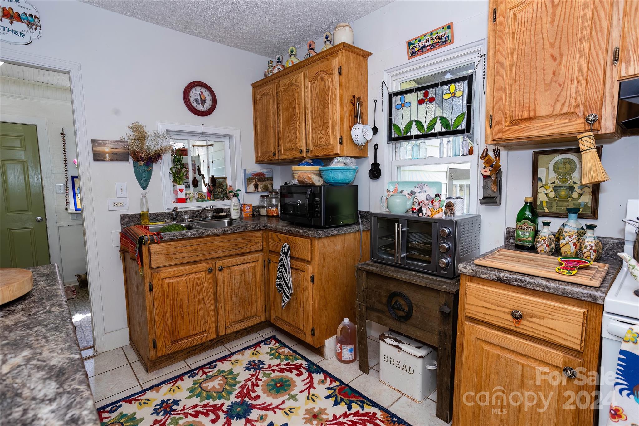 3786 Broad Street Clyde, NC 28721 - Photo 16 of 48 a kitchen with stainless steel appliances granite countertop a stove a sink and a refrigerator