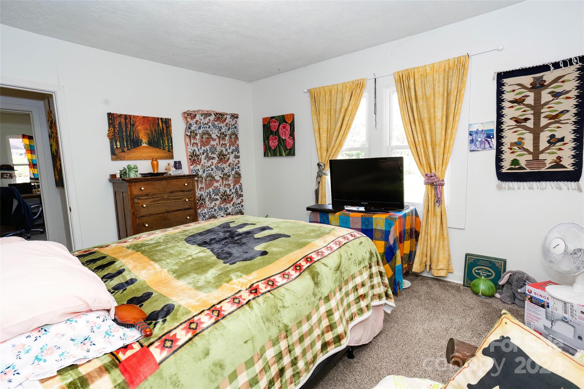 3786 Broad Street Clyde, NC 28721 - Photo 18 of 48 a bedroom with a bed and flat screen tv