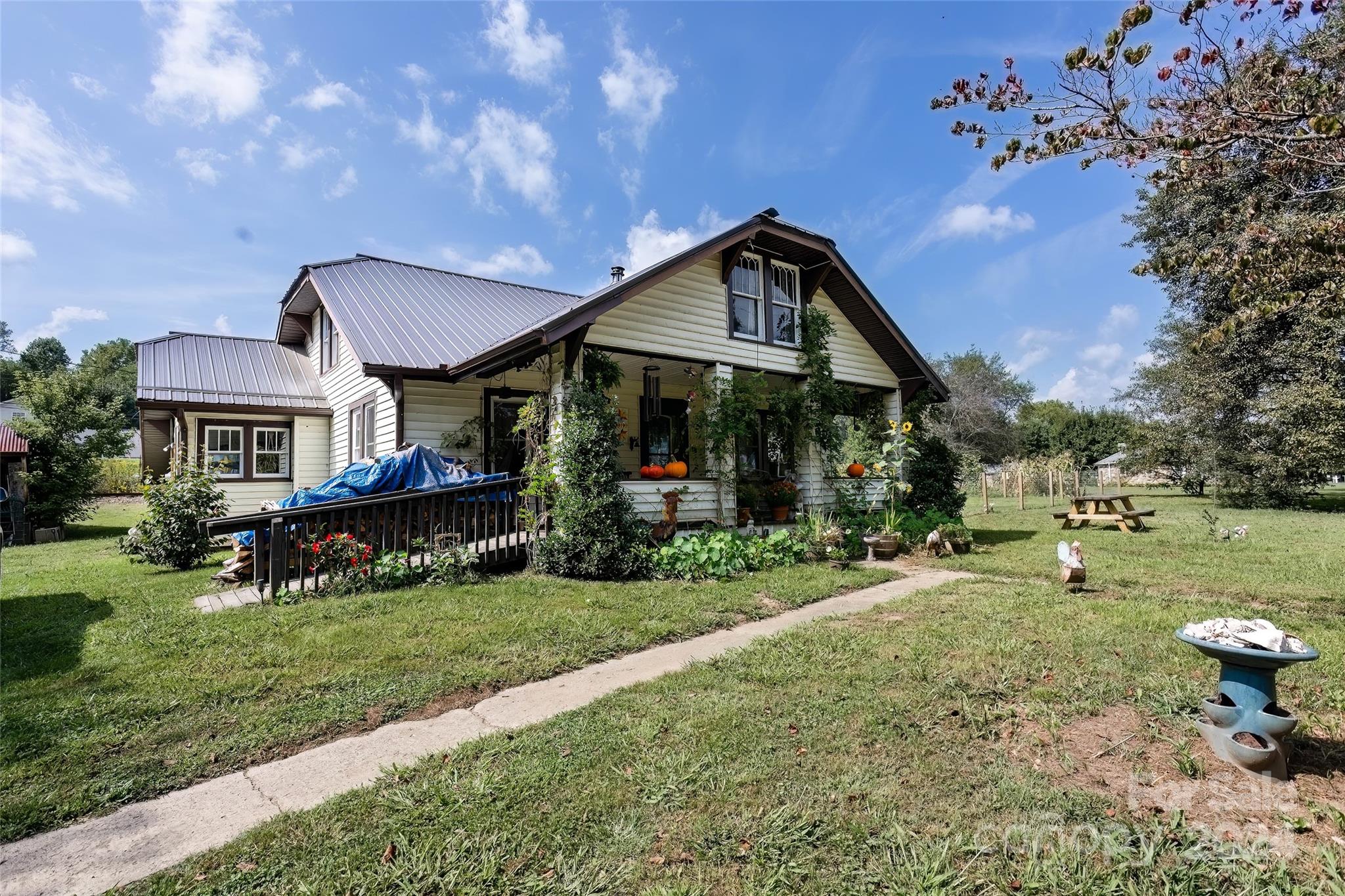 3786 Broad Street Clyde, NC 28721 - Photo 3 of 48 a view of a house with a yard porch and sitting area