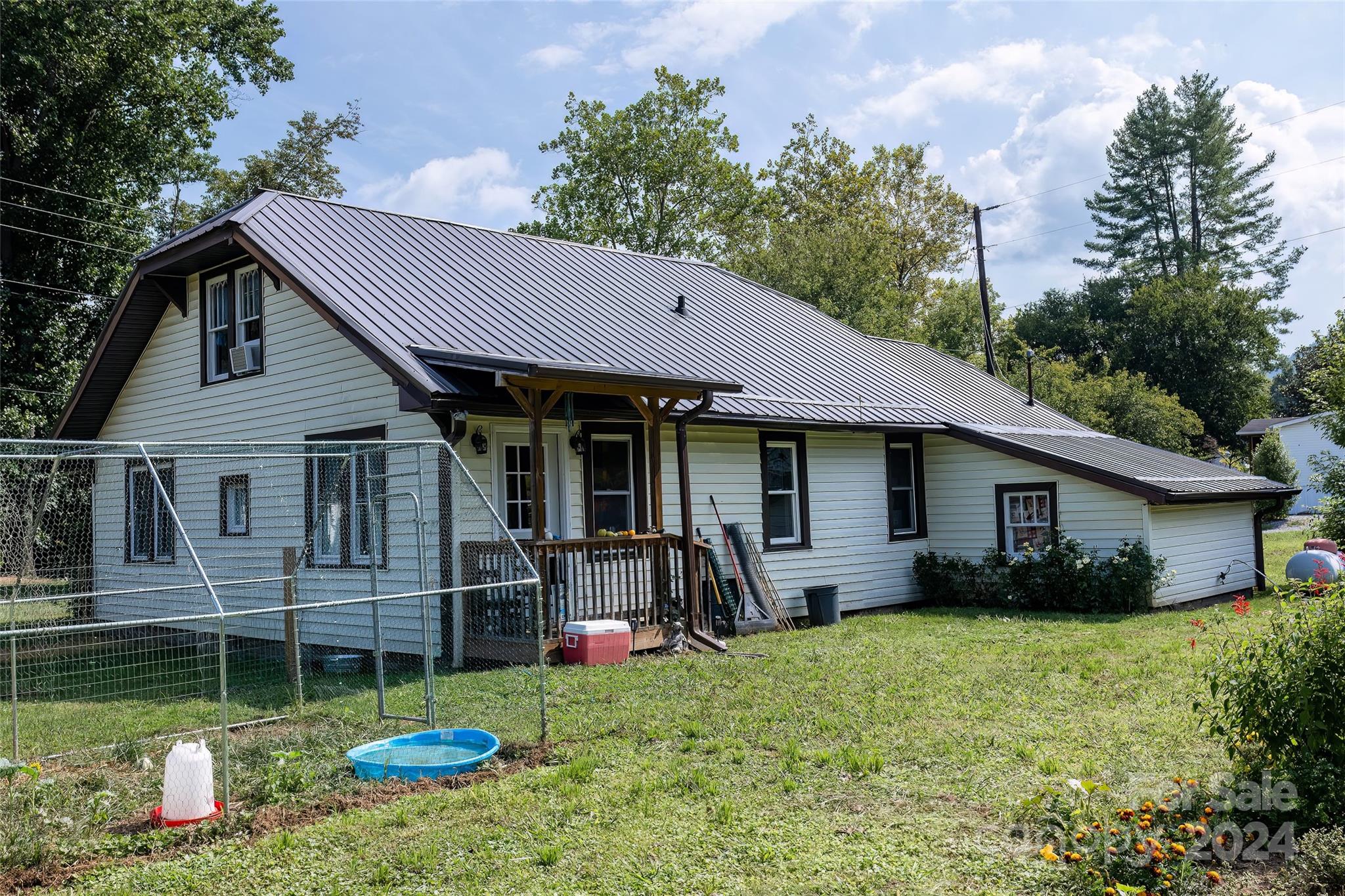 3786 Broad Street Clyde, NC 28721 - Photo 37 of 48 a front view of a house with garden