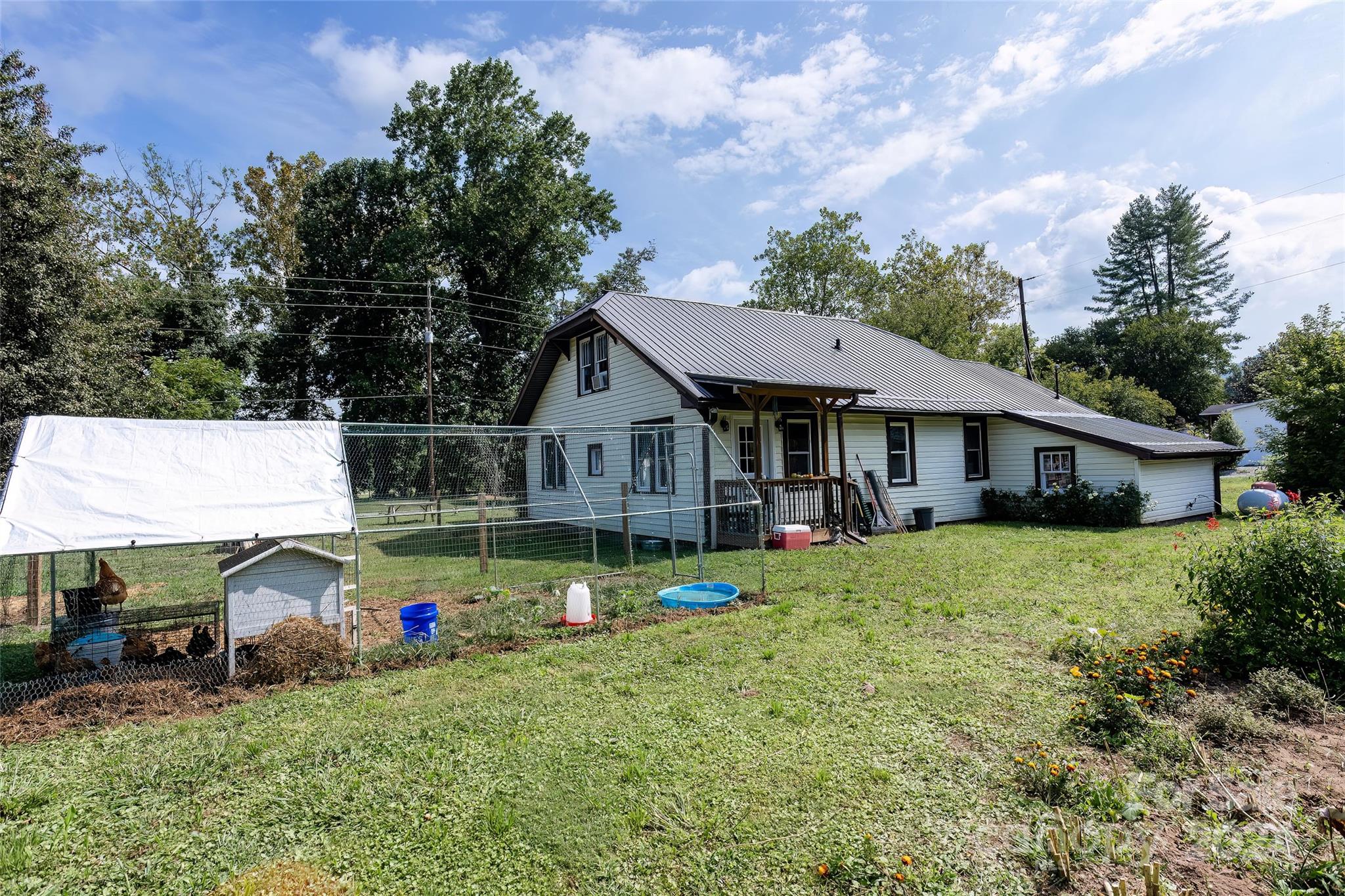 3786 Broad Street Clyde, NC 28721 - Photo 38 of 48 a view of a house with a yard and sitting area