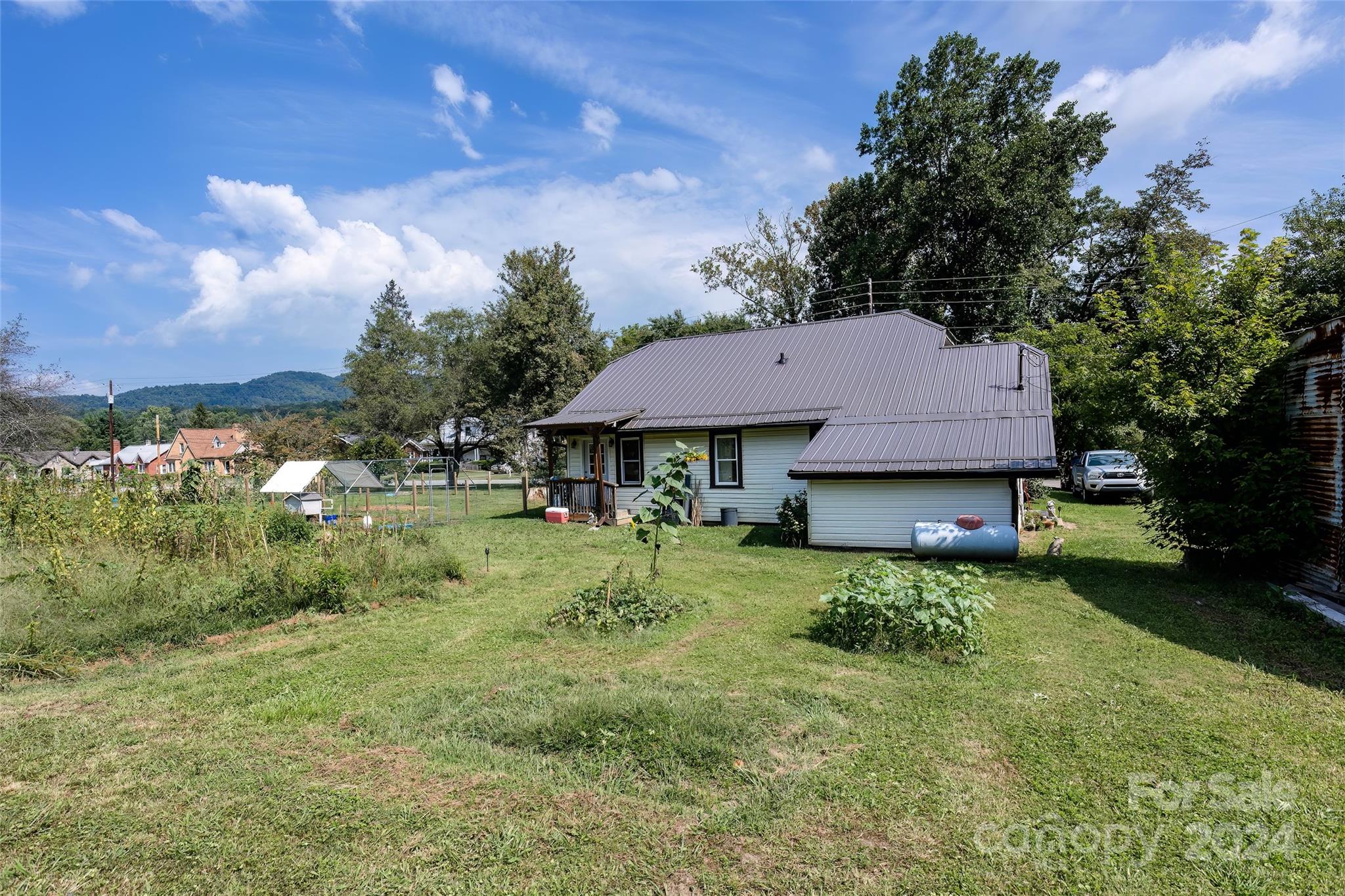 3786 Broad Street Clyde, NC 28721 - Photo 39 of 48 a view of a house with a yard