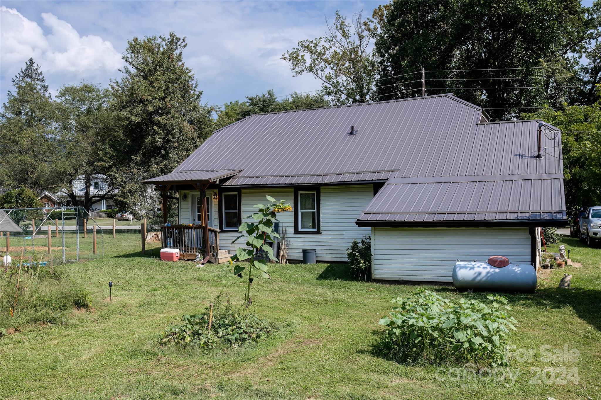 3786 Broad Street Clyde, NC 28721 - Photo 40 of 48 a front view of a house with garden