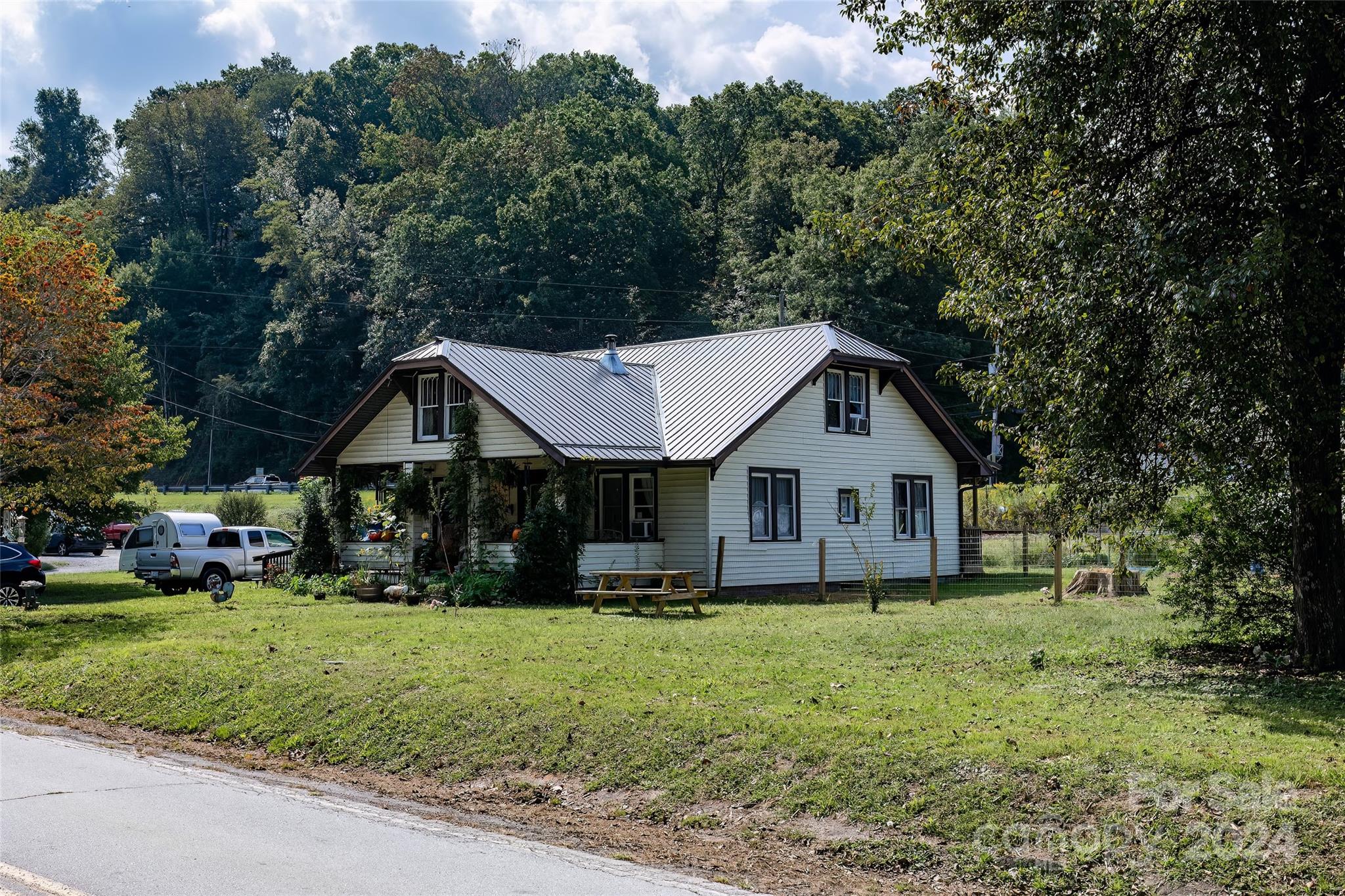 3786 Broad Street Clyde, NC 28721 - Photo 4 of 48 a front view of a house with a yard and trees